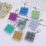 Button press fidget keychains with alternate button layouts