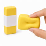 Hand gently squeezing a yellow slow rising butter squishy stress toy