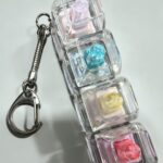 Transparent switch detail of a 4-key keyboard fidget keychain