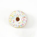 White frosted donut squishy toy with colorful sprinkles