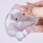 Hand squeezing transparent glitter jellyfish squishy toy