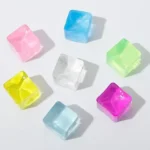 Assorted color translucent ice cube squishy toys on white background