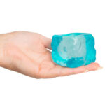 Blue ice cube squishy toy resting in a hand for size reference