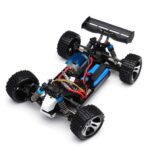 Exposed 1:16-class 4WD RC buggy chassis showing motor, battery, suspension and drivetrain layout