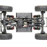 RC crawler underside showing four-wheel drivetrain suspension links and battery layout