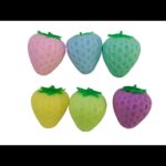 Strawberry squishy toys in assorted pastel colors on white background